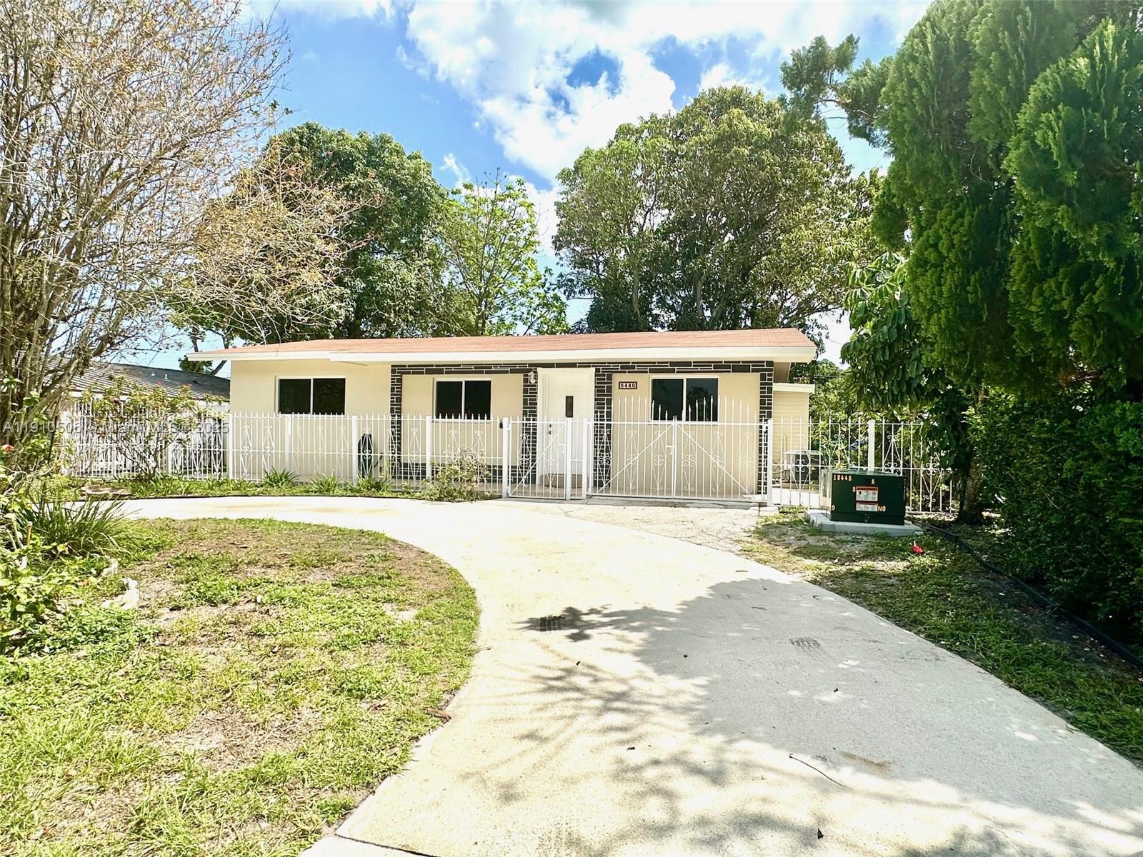 6440 Southwest 20th Street Miramar, FL 33023 - Photo 29 of 31 a view of a house with pool and trees in the background