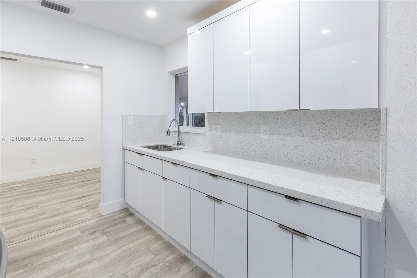 6440 Southwest 20th Street Miramar, FL 33023 - Photo 3 of 31 a kitchen with granite countertop white cabinets and a sink