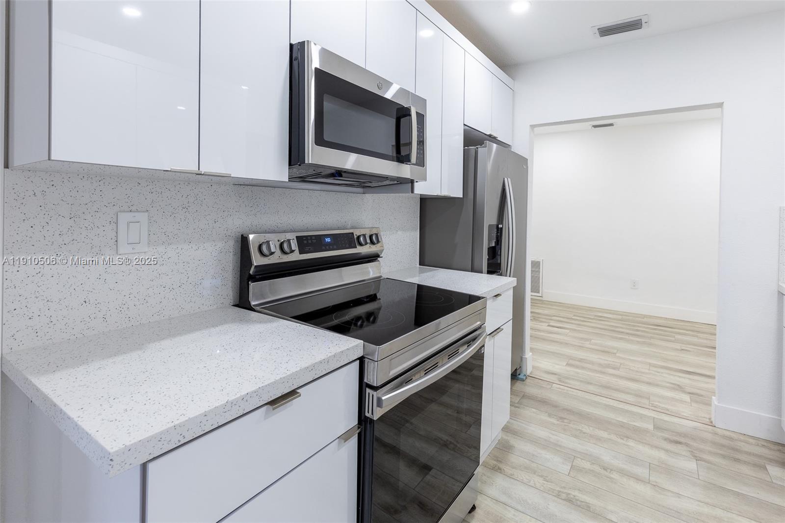 6440 Southwest 20th Street Miramar, FL 33023 - Photo 4 of 31 a kitchen with stainless steel appliances a stove microwave and sink