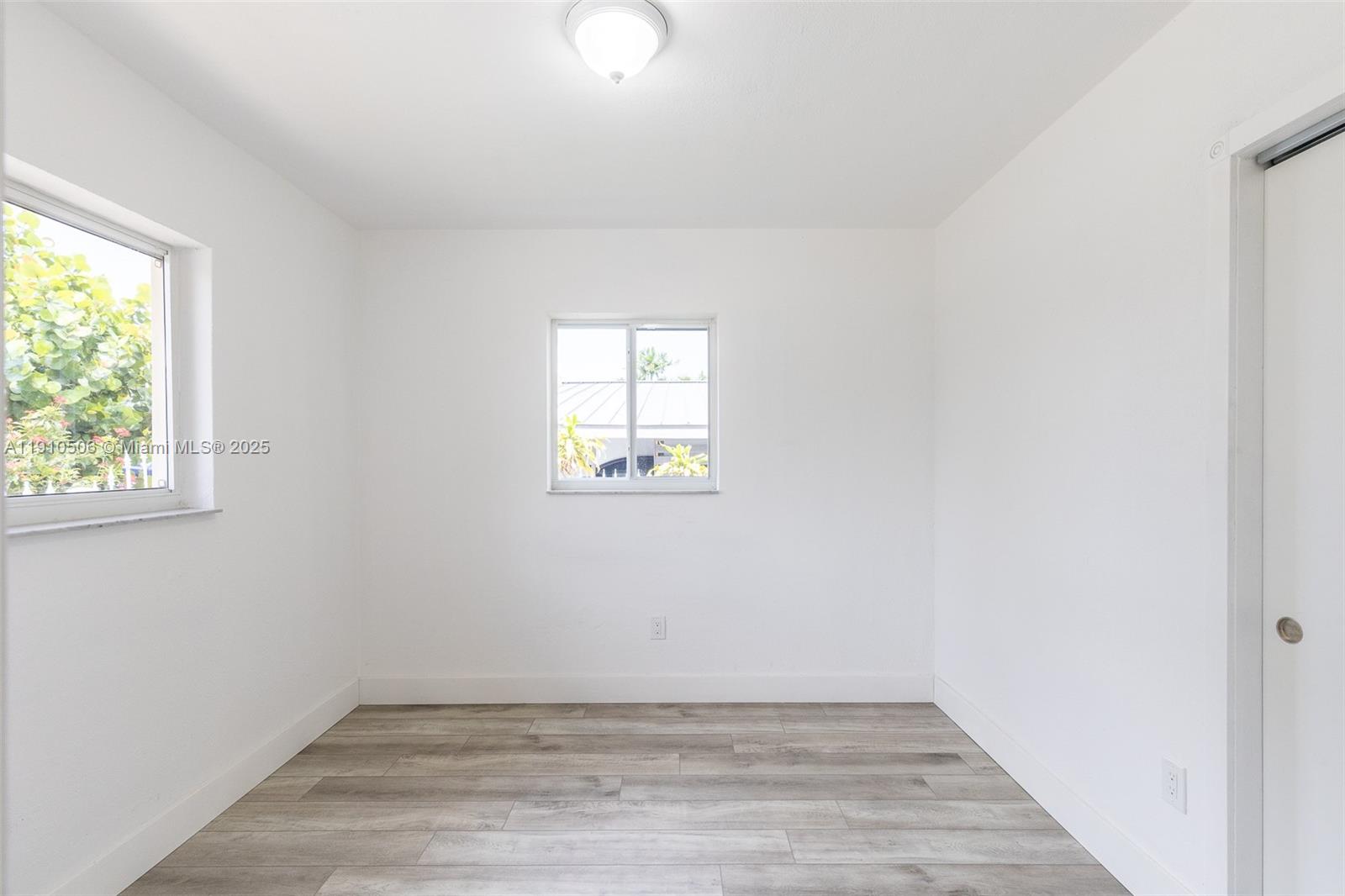 6440 Southwest 20th Street Miramar, FL 33023 - Photo 5 of 31 an empty room with wooden floor and windows