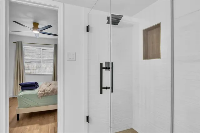 a bedroom with a bed and a window