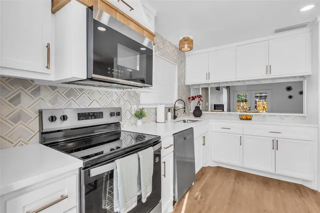 a kitchen with appliances cabinets and a sink