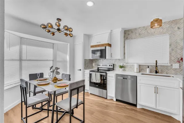 a kitchen with a table and chairs