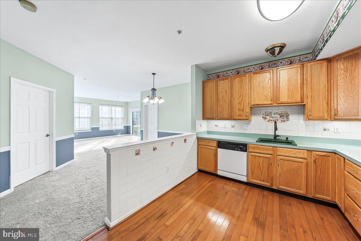 1588 Nicklaus Drive Springfield, PA 19064 - Photo 11 of 25 a large kitchen with a wooden floor and white appliances