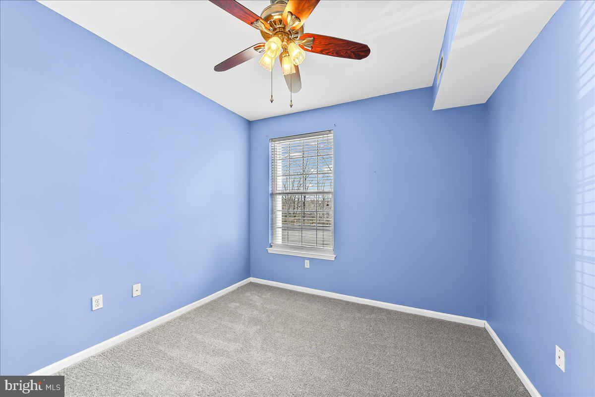 1588 Nicklaus Drive Springfield, PA 19064 - Photo 20 of 25 an empty room with a window and a fan