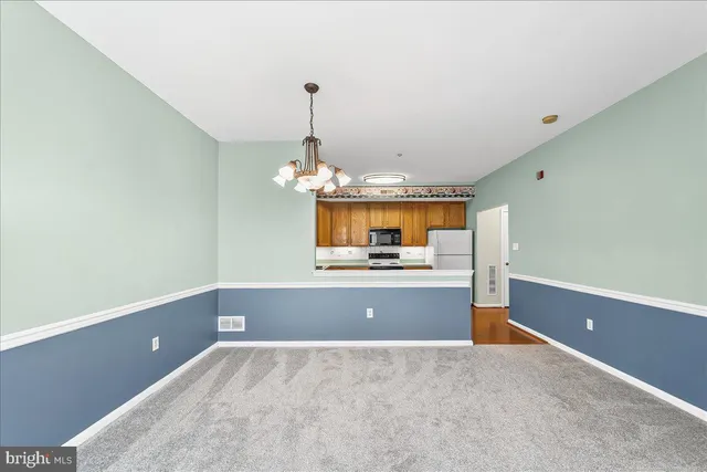 a kitchen with stainless steel appliances granite countertop a stove sink and cabinets