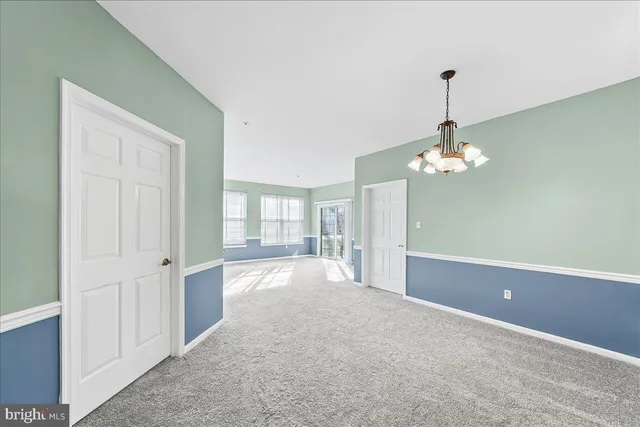 a large kitchen with a wooden floor and white appliances