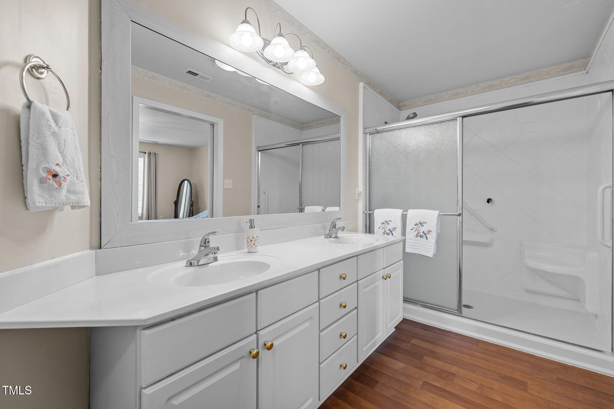 1613 Bulon Drive Cary, NC 27518 - Photo 11 of 26 a bathroom with a double vanity sink mirror and shower