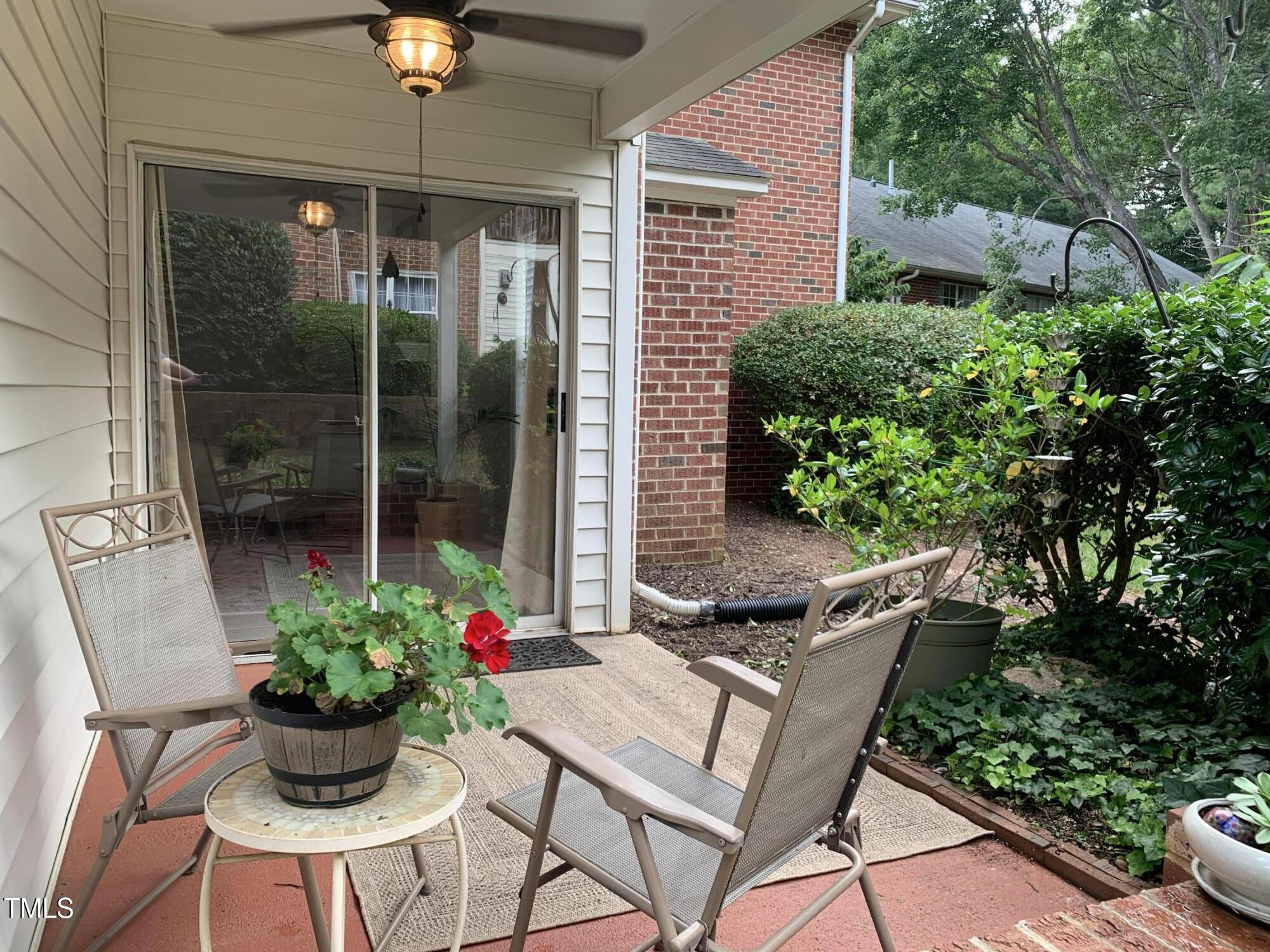 1613 Bulon Drive Cary, NC 27518 - Photo 15 of 26 a view of a chair and table in the patio and a couple of potted plants