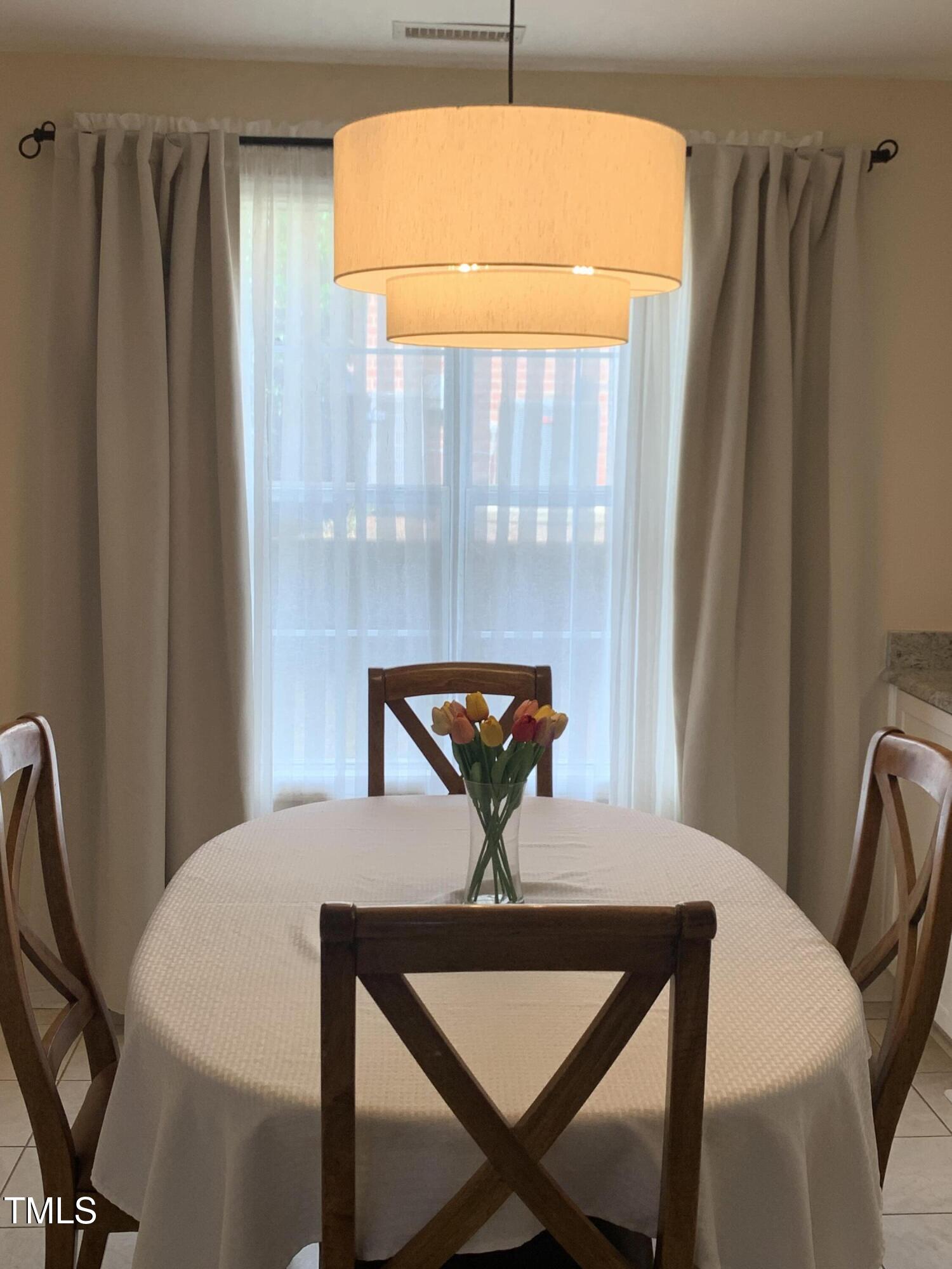 1613 Bulon Drive Cary, NC 27518 - Photo 3 of 26 a view of a dining room with furniture and wooden floor
