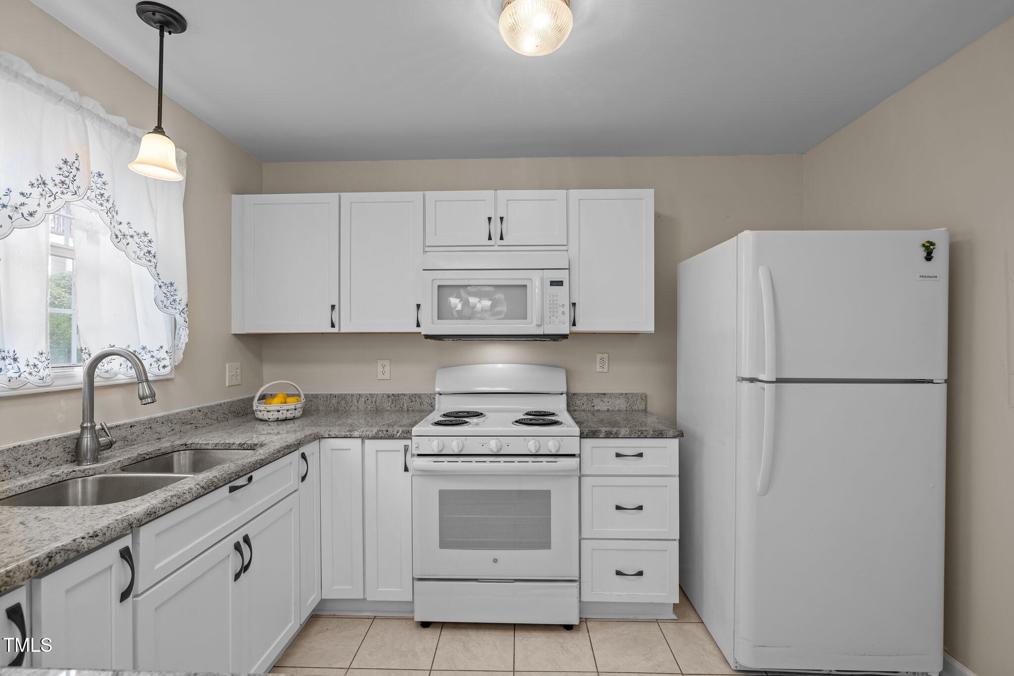 1613 Bulon Drive Cary, NC 27518 - Photo 6 of 26 a kitchen with cabinets stainless steel appliances and a sink