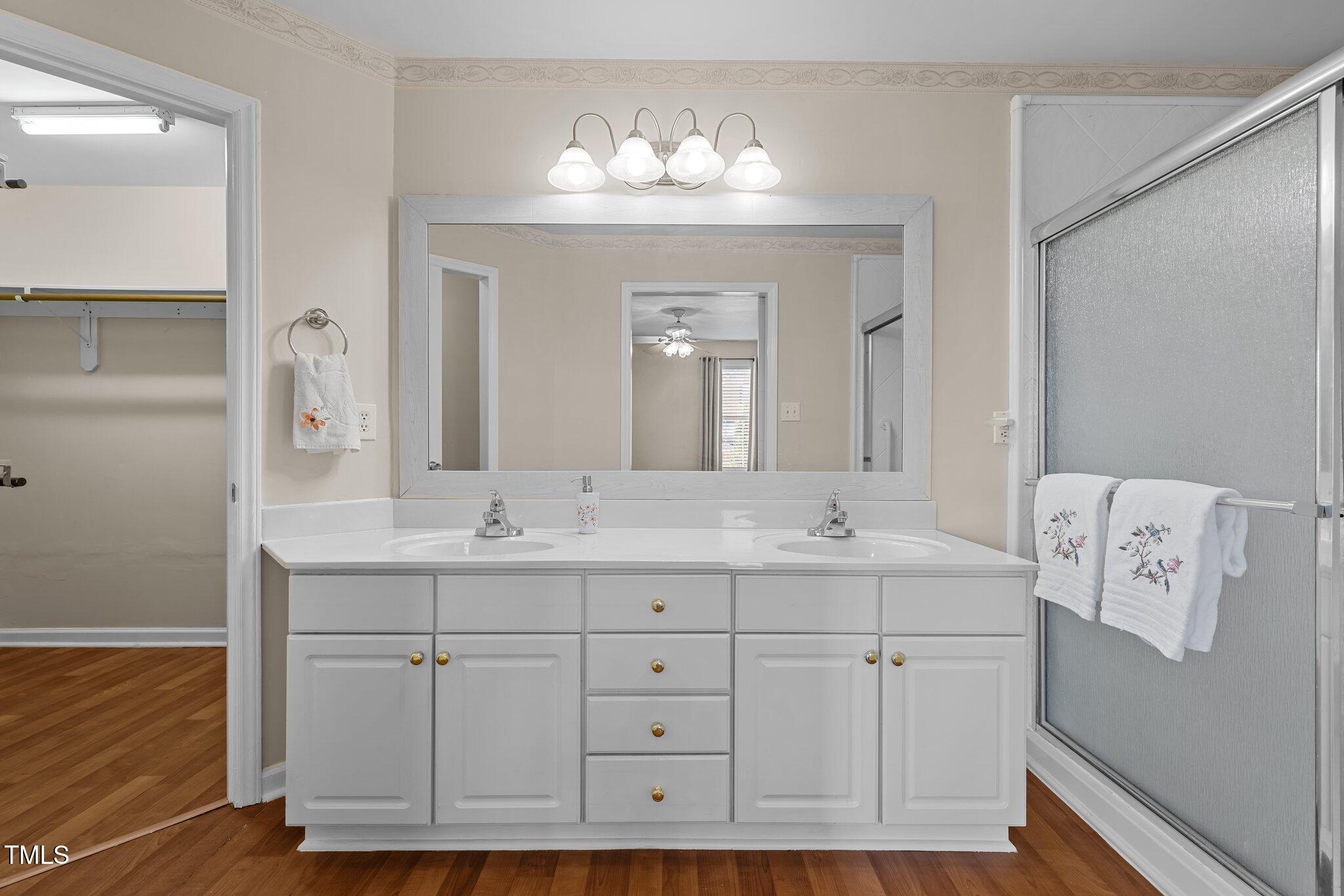 1613 Bulon Drive Cary, NC 27518 - Photo 10 of 26 a bathroom with a double vanity sink and a mirror