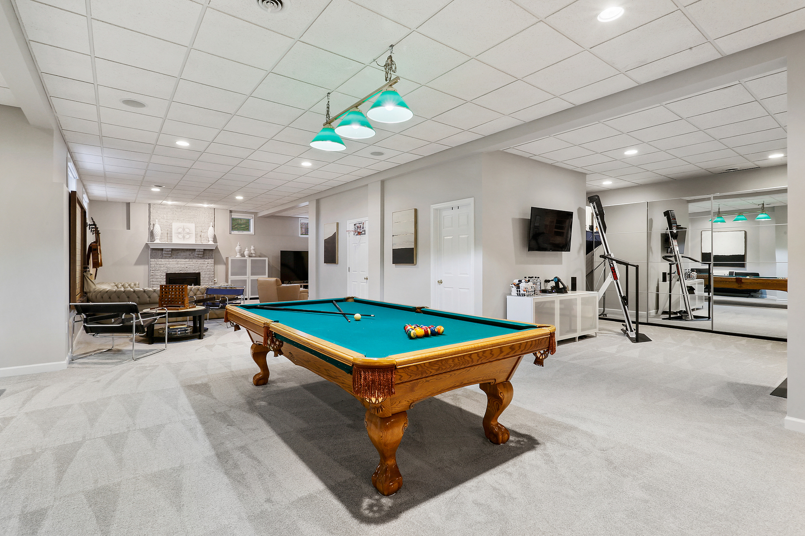 65 Ruffled Feathers Drive Lemont, IL 60439 - Photo 36 of 44 a living room with furniture pool table and a flat screen tv