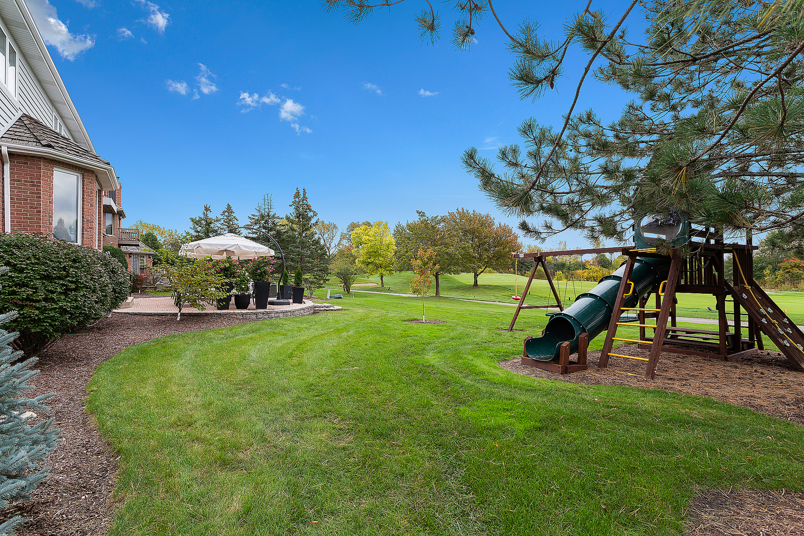 65 Ruffled Feathers Drive Lemont, IL 60439 - Photo 7 of 44 a view of a park with slide and a bench