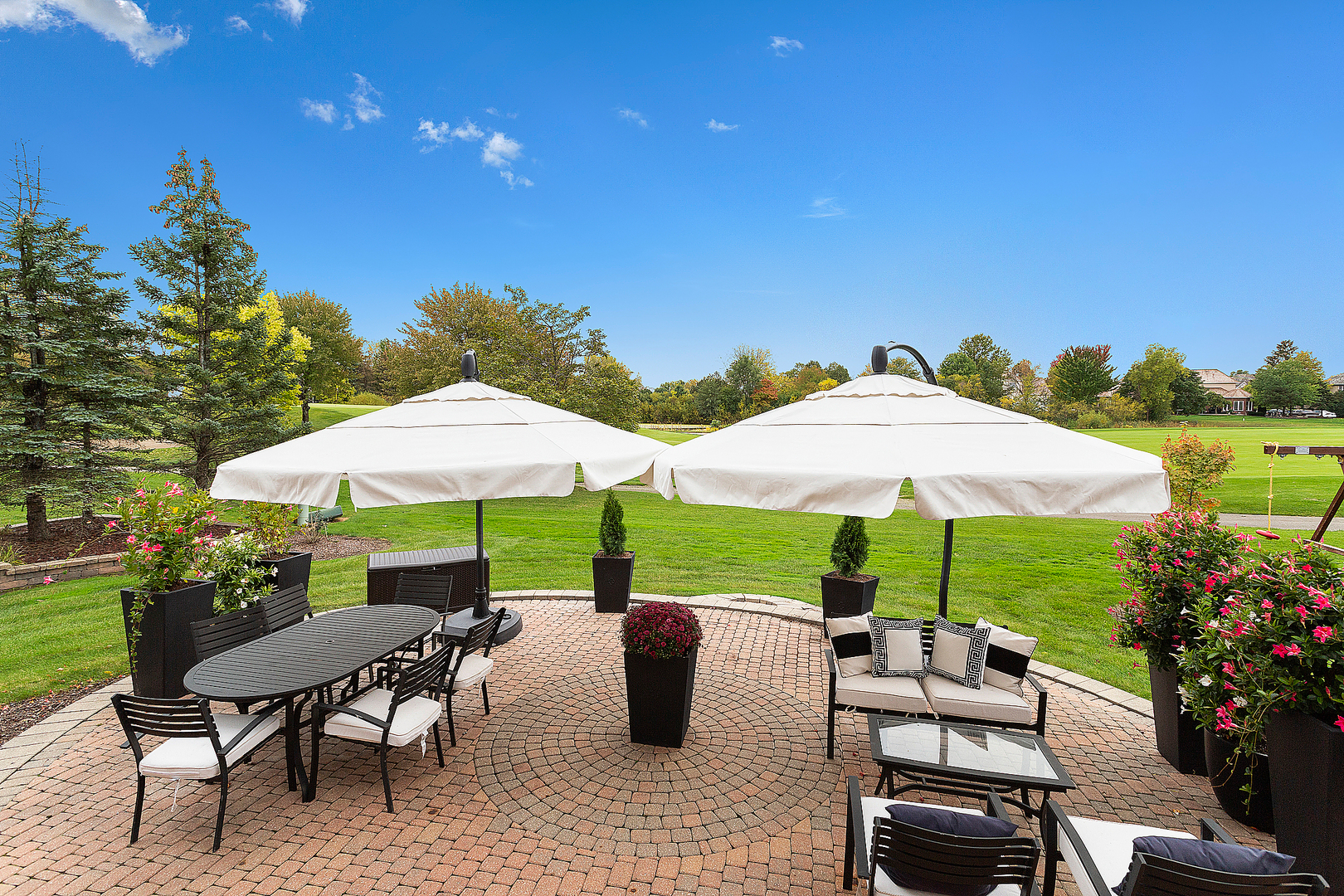 65 Ruffled Feathers Drive Lemont, IL 60439 - Photo 8 of 44 a view of table and chairs under an umbrella