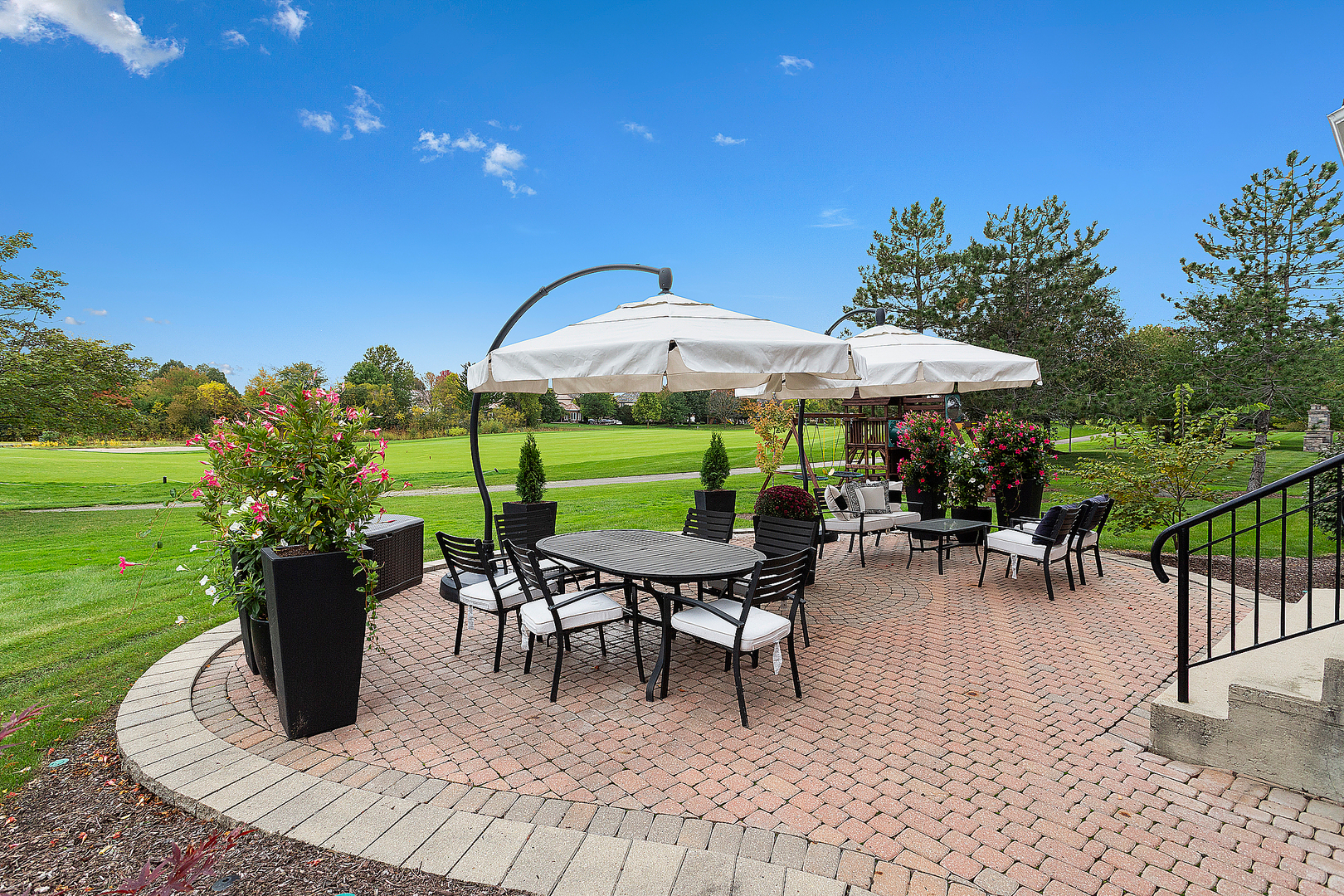 65 Ruffled Feathers Drive Lemont, IL 60439 - Photo 9 of 44 a view of a patio with a table chairs and a yard