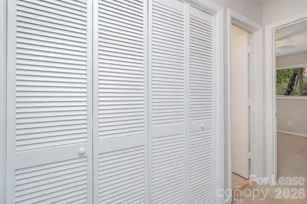 a view of empty room with wooden floor and sliding glass door