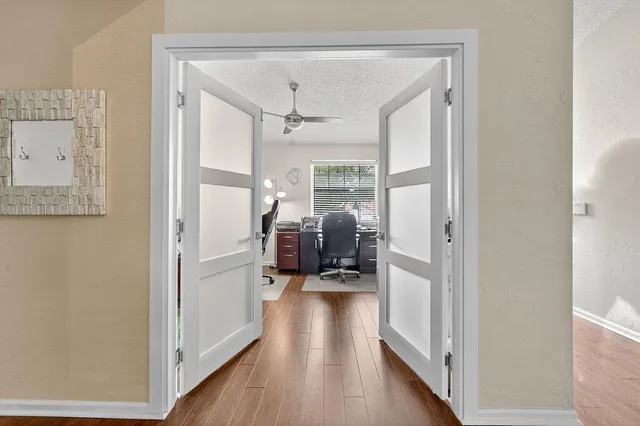 a view of a hallway with a wooden floor