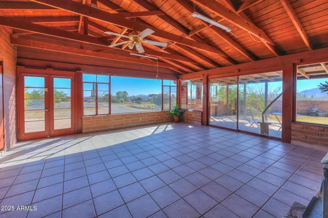 a view of empty room with wooden floor and fireplace