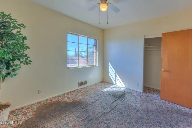 a white toilet sitting next to a white walls