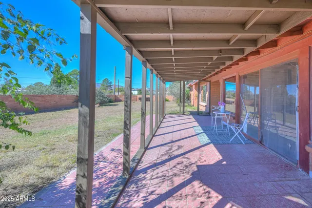 a front view of a building with palm trees