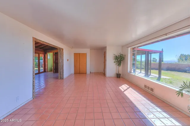 a view of an entryway with wooden floor and garden