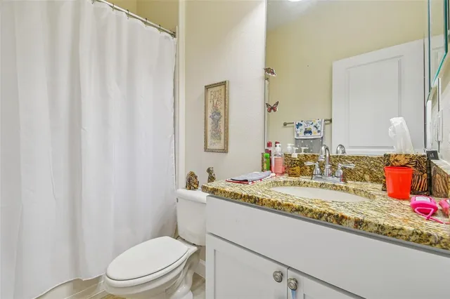 a bedroom with large bed and a chandelier