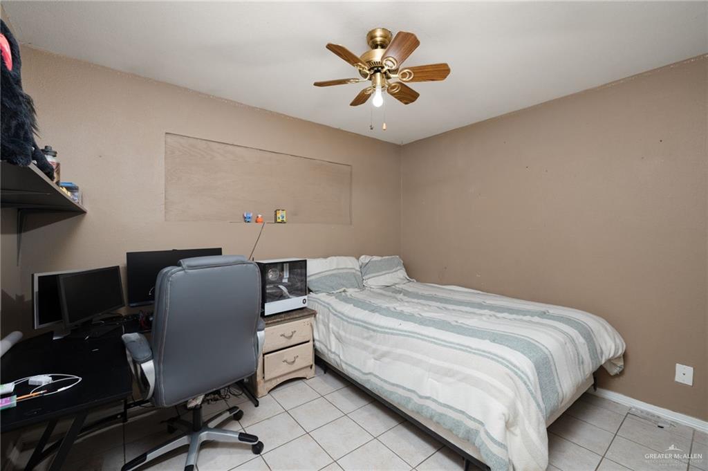 1222 South Bluebonnet Street Pharr, TX 78577 - Photo 11 of 17 a bedroom with a bed and a chair