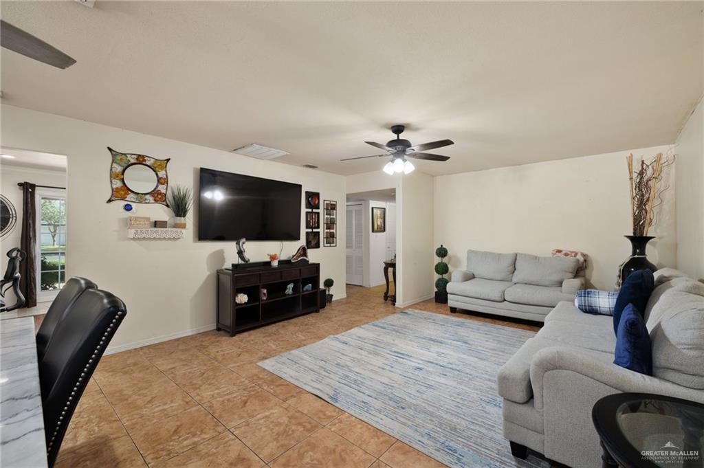 1222 South Bluebonnet Street Pharr, TX 78577 - Photo 3 of 17 a living room with furniture and a flat screen tv