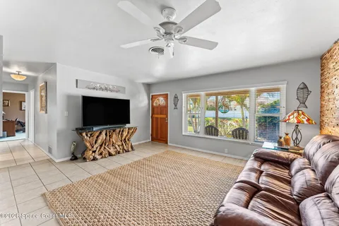 a spacious bedroom with a large bed and a flat screen tv