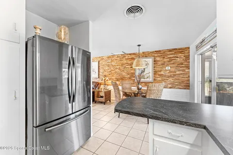 a kitchen with a refrigerator a stove and cabinets