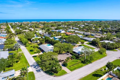 an aerial view of residential houses with outdoor space