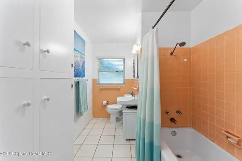a bathroom with a bathtub a toilet and a shower
