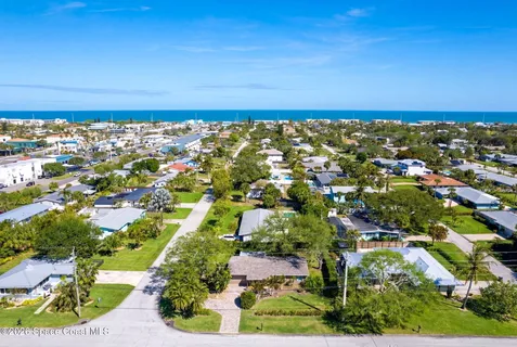an aerial view of residential building and ocean