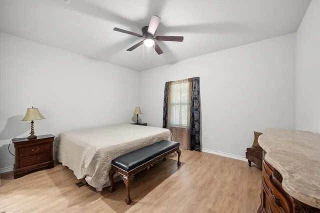 a bedroom with a bed and a mirror