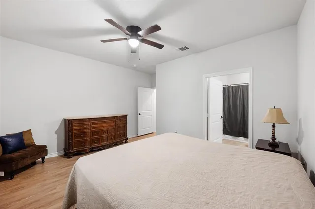 a bedroom with a bed and dresser