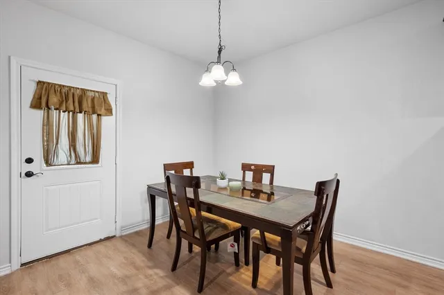 a view of a dining room with a table and chairs
