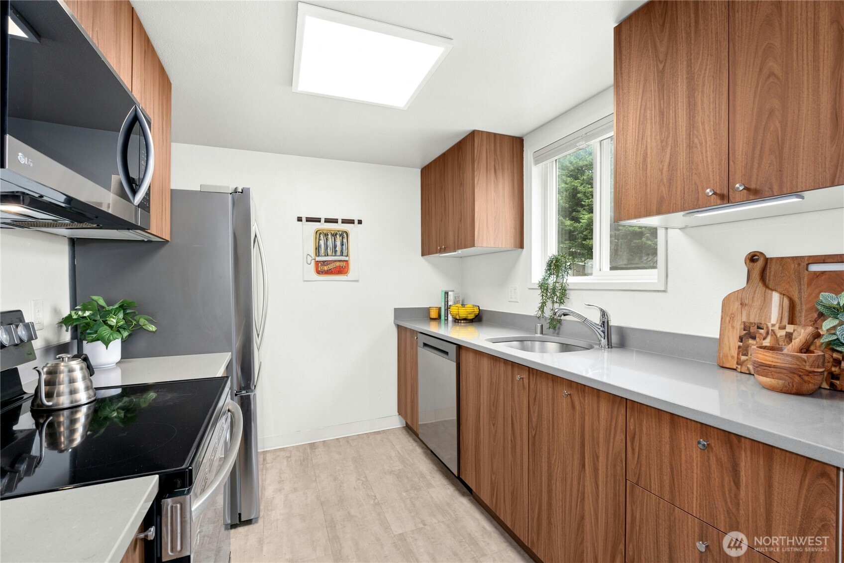 9523 Northeast 180th Street, Unit A102 Bothell, WA 98011 - Photo 13 of 29 a kitchen with stainless steel appliances granite countertop a sink stove and cabinets