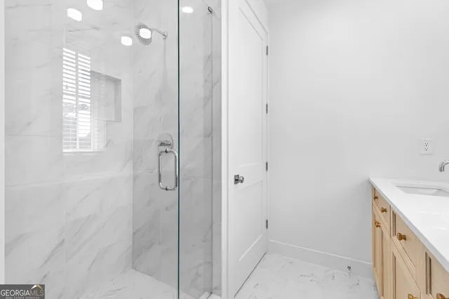 a bathroom with a shower sink and mirror