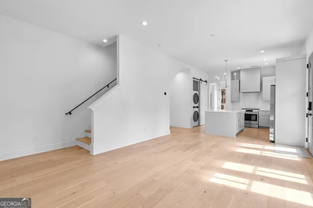 a view of a kitchen with refrigerator and white cabinets