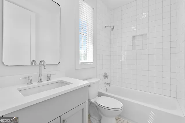 a bathroom with a sink a toilet and bathtub