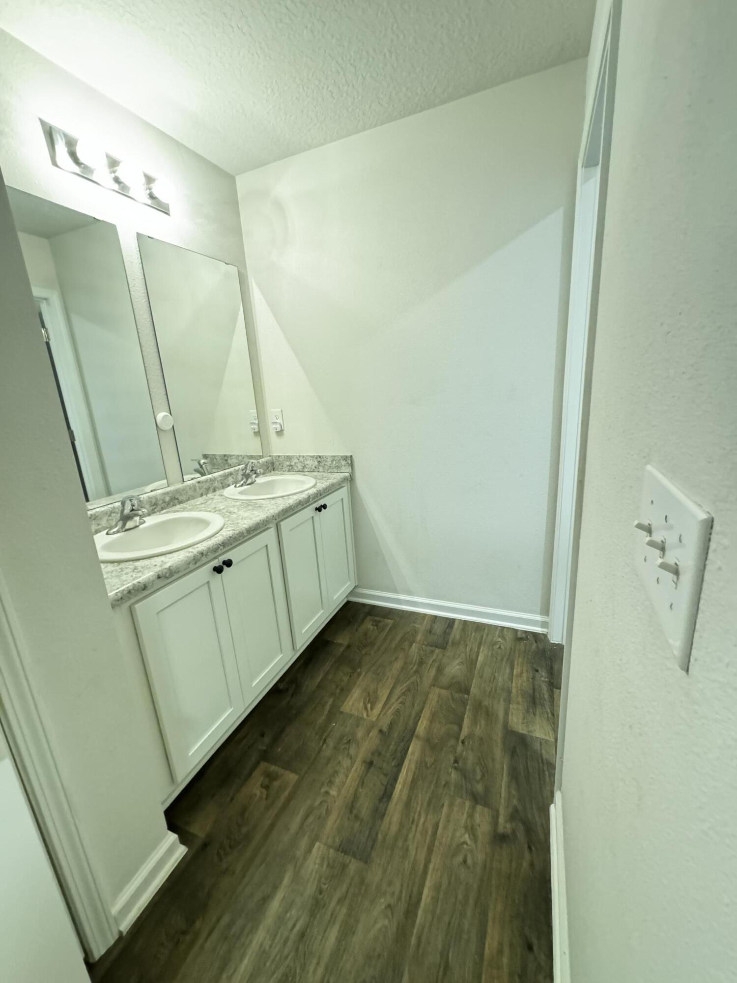 5444 Merlin Way Milton, FL 32583 - Photo 11 of 20 a bathroom with a sink a mirror and shower