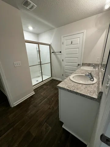 a bathroom with a granite countertop sink and a mirror
