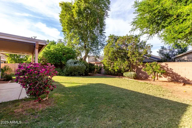 a view of a house with a yard and basketball court