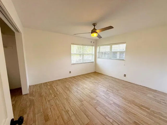 wooden floor in an empty room with a window