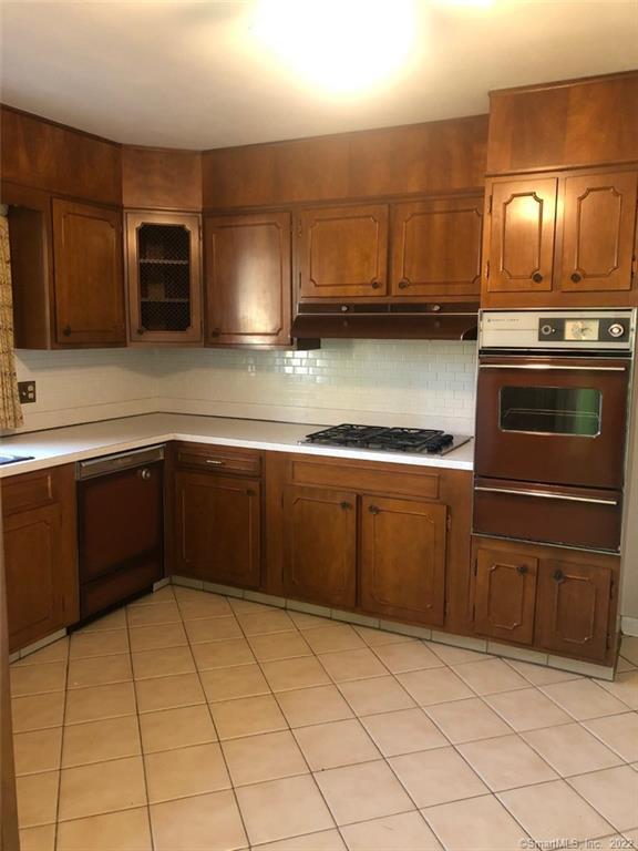 a kitchen with stainless steel appliances granite countertop a sink and a stove