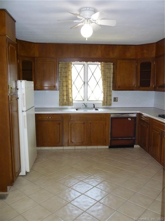 927 Burroughs Road Fairfield, CT 06825 - Photo 11 of 33 a large kitchen with cabinets and a refrigerator