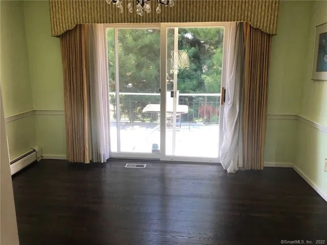 a view of room with window and hardwood floor
