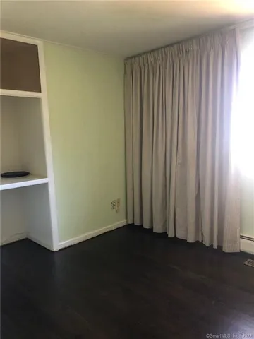 an empty room with wooden floor