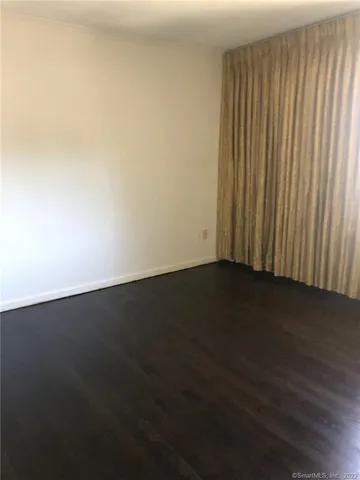 a bathroom with a sink a toilet a mirror and window